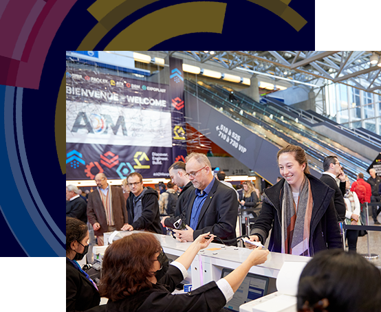 Attendees being welcomed and assisted at the print badge station