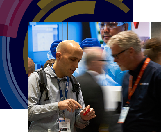 Man shows red product to man in blue shirt