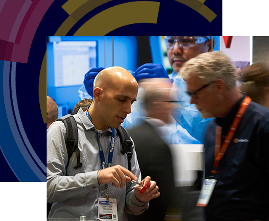 Man shows red product to man in blue shirt